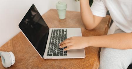 A person typing on a laptop.