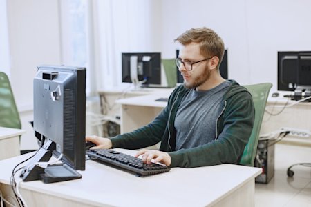 An IT administrator working on his computer.