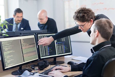 Two developers reading code via Splashtop remote access software