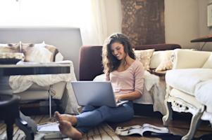 A woman smiling while using Splashtop on her laptop to work from home.