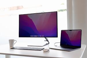 A laptop and external display sitting on a desk.