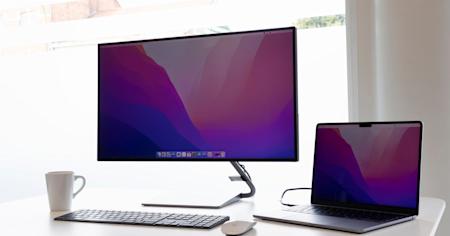 A laptop and external display sitting on a desk.