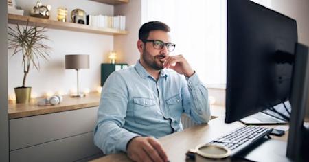 IT technician at computer researching remote software options for secure access