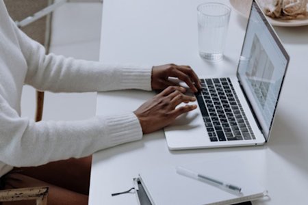 Person using a laptop and researching Splashtop Business Access, listed among top 5 remote desktop features online