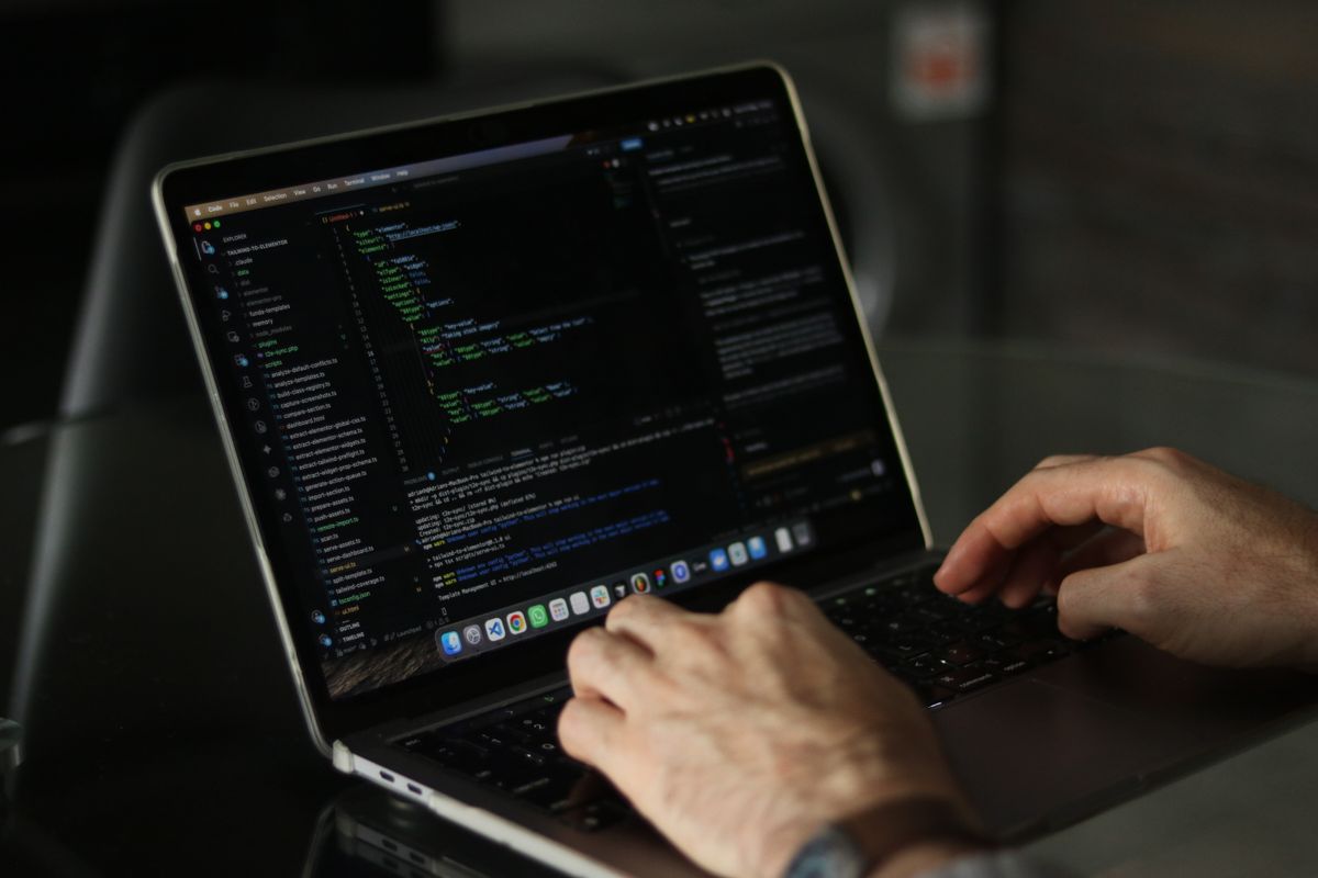 Hands typing on a laptop keyboard.