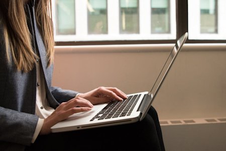 A person using a laptop computer.