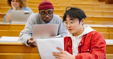 Two university students studying in a classroom