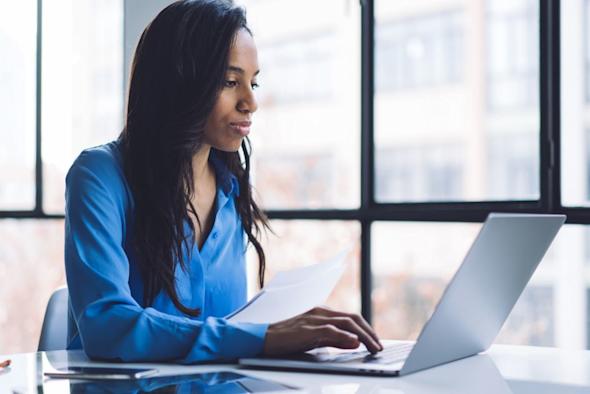 Woman working at desk with laptop computer