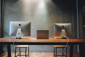 Apple computers sitting on a desk.