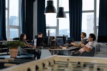 A group of people working on computers in an office.