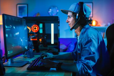 Person in his room playing video games on his computer