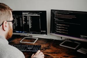 An IT support technician working at a computer