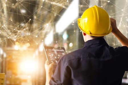 A construction worker on an IoT tablet.