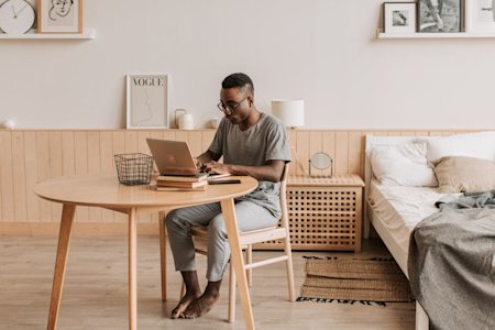 An IT worker working from home on a laptop.