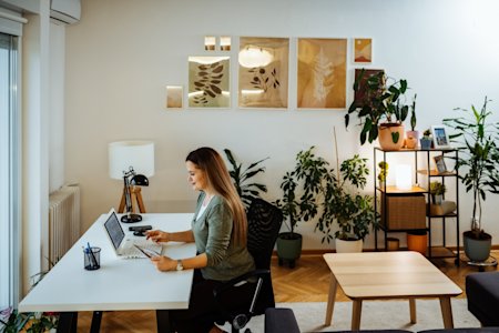 A hybrid employee using Splashtop's remote access software from home to stay connected with her office computer.