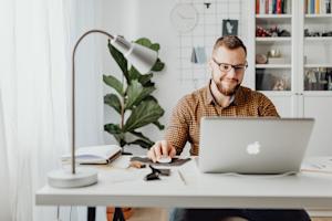 A man working remotely in his home office.