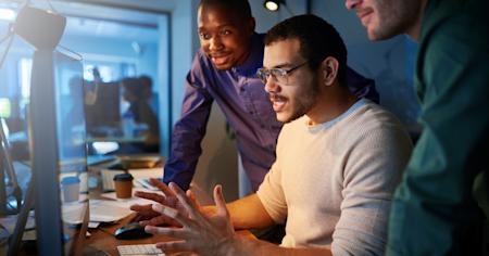 IT team collaborating on endpoint monitoring at a workstation, using Splashtop AEM.
