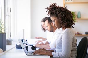 Team collaborating in a shared workspace using multi-user remote desktop access.
