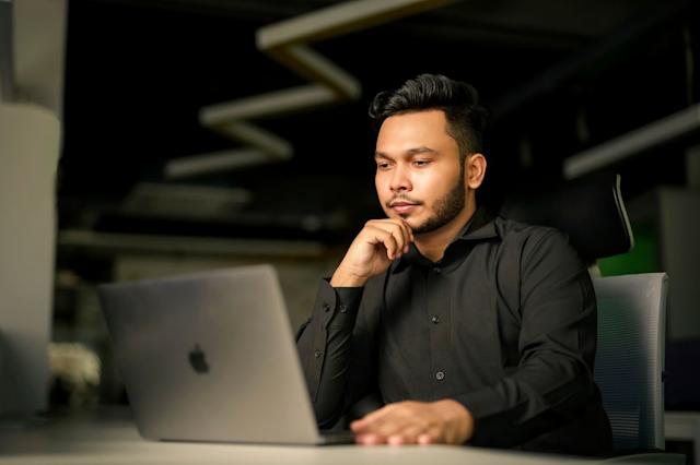 A person working on his laptop.