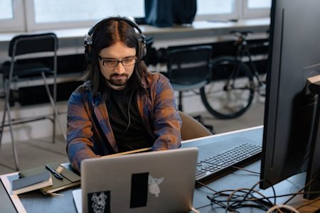 A man typing on a computer in an office.