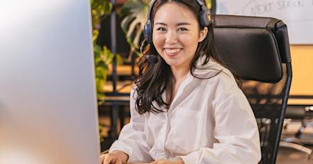 An IT support agent working at their computer.