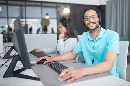 Two IT techs working at their computers.
