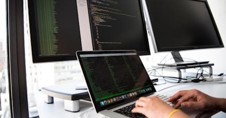 Multiple screens displaying code snippets and programming tools