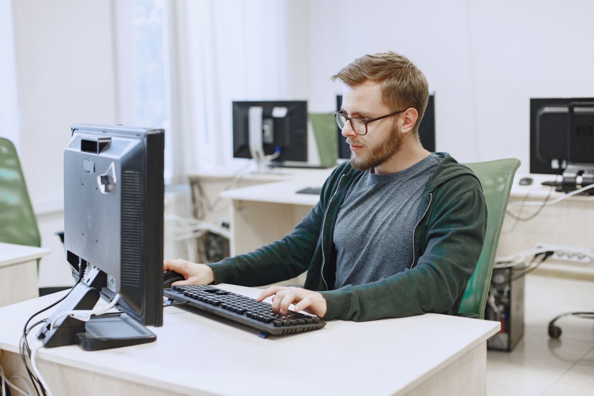 A man working on his computer in an office.