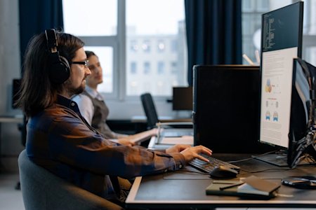 Two IT workers on their computers.