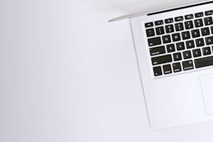 A laptop on a white table.