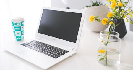A Chromebook sitting on a desk in a home office.