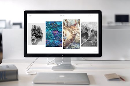 A computer and monitor on a desk.