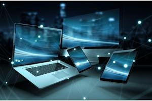 Photo of several laptops, phones, and tablets