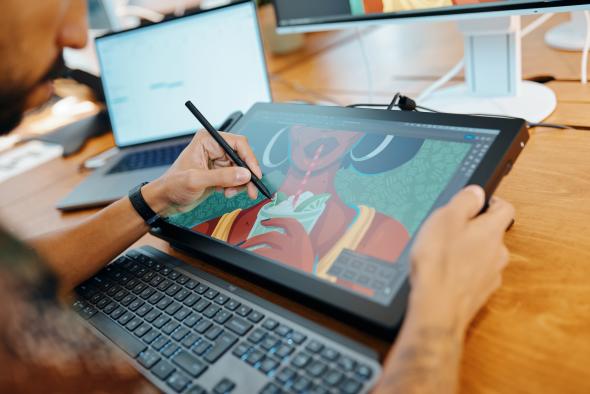 Person using a pen to draw on a Wacom Cintiq Pro 17 tablet