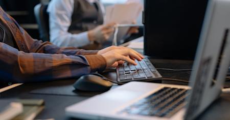 A person working on a computer in an office.