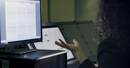 A woman sitting at a desktop computer.
