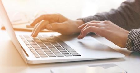 A laptop and an iPhone on a desk