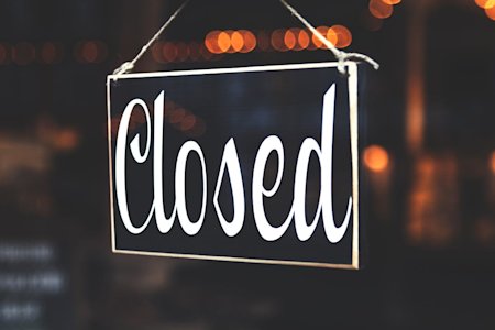 A "Closed" sign in a business window.