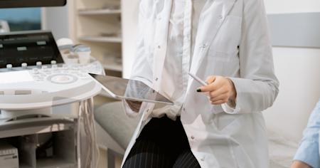A doctor using remote access software to access patient data from her tablet.