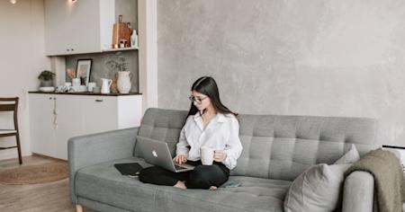 A woman working remotely by using a laptop.