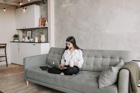 A woman working remotely by using a laptop.