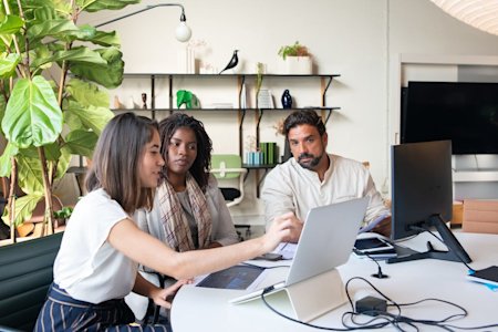 Coworkers in an office looking at a computer screen.