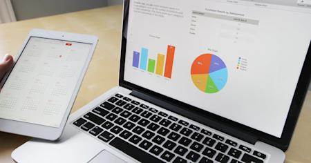 A laptop computer and tablet on an office desk.