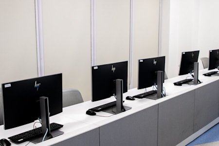 A row of computers in a computer lab.