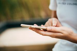 A person typing on a smartphone.