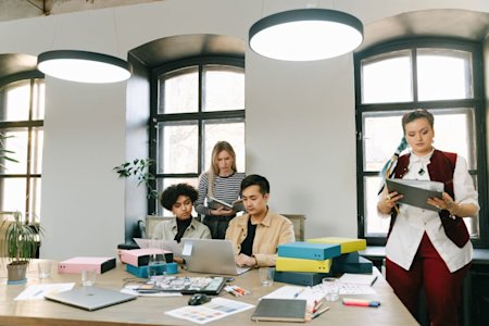 People working in a small business office with their laptops.