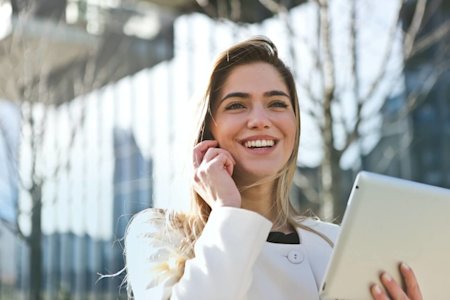 A woman using Splashtop on her tablet, saving her more than a TeamViewer discount or coupon would.