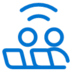 Blue icon showing two stylized people sitting next to each other, with curved lines above them resembling a wireless signal, on a light gray background.
