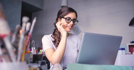 A woman working remotely using a Chromebook.
