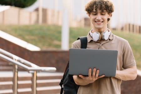 Student using laptop to remotely access a computer